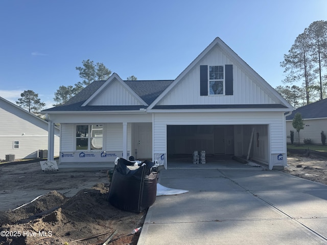 view of front of property featuring central AC, a shingled roof, and driveway