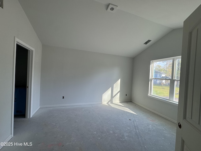 interior space with visible vents, baseboards, and vaulted ceiling