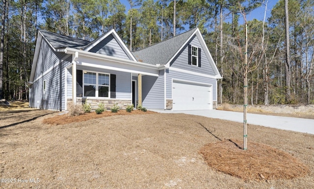 view of front facade with concrete driveway, a garage, stone siding, and covered porch