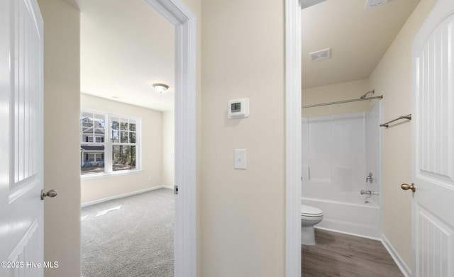 full bath with shower / tub combination, visible vents, baseboards, and toilet