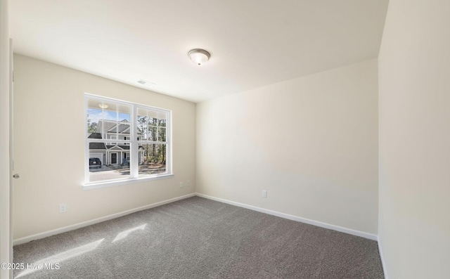 spare room featuring visible vents, baseboards, and carpet floors