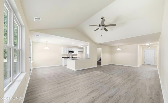 unfurnished living room featuring high vaulted ceiling, ceiling fan, and light wood-type flooring