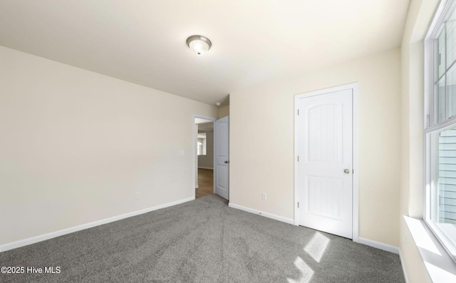 unfurnished bedroom featuring baseboards and carpet