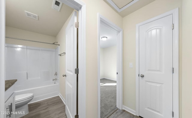 full bathroom with vanity, baseboards, visible vents, and wood finished floors