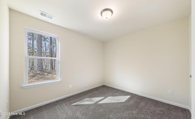 empty room featuring baseboards, visible vents, and carpet floors