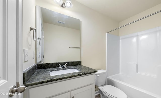 bathroom featuring shower / bathtub combination, vanity, visible vents, and toilet