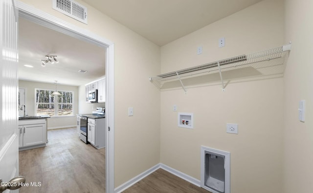 laundry area with visible vents, laundry area, hookup for an electric dryer, wood finished floors, and hookup for a washing machine