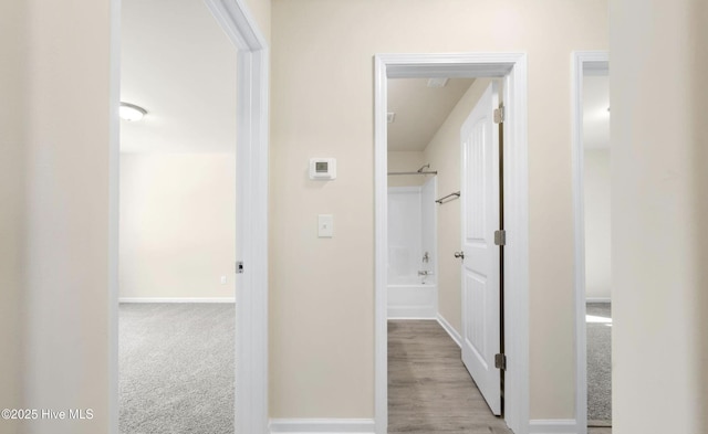 corridor with light colored carpet