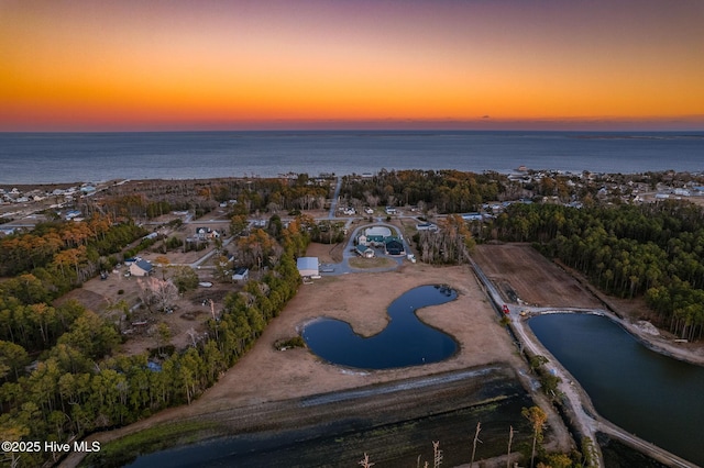 aerial view at dusk with a water view