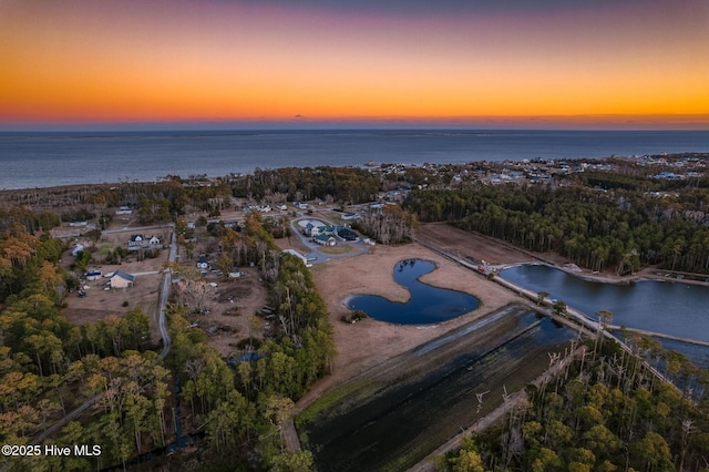 aerial view at dusk with a water view