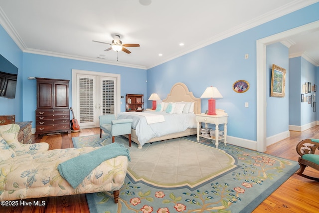 bedroom with french doors, crown molding, and wood finished floors