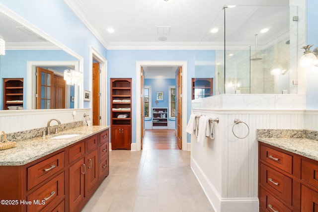 full bathroom featuring recessed lighting, a walk in shower, vanity, and ornamental molding