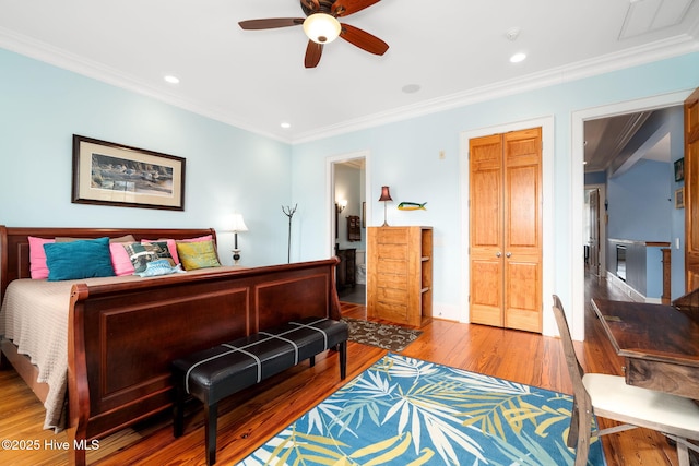 bedroom with recessed lighting, wood finished floors, and ornamental molding