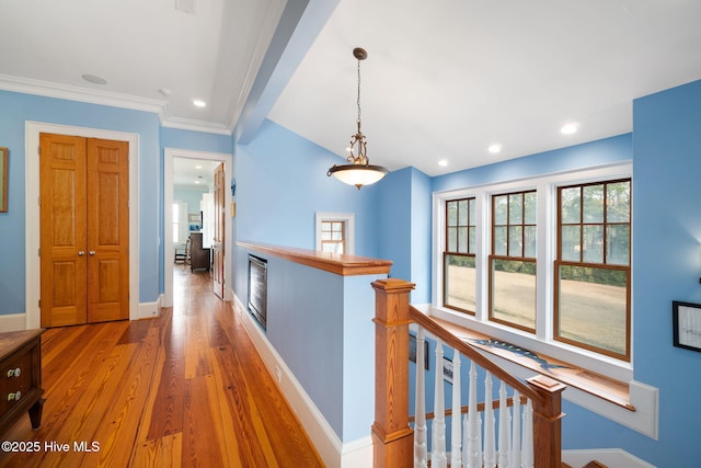 hall with crown molding, baseboards, an upstairs landing, recessed lighting, and wood finished floors