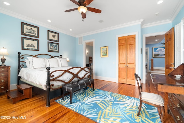 bedroom with baseboards, ornamental molding, recessed lighting, light wood-style flooring, and a closet