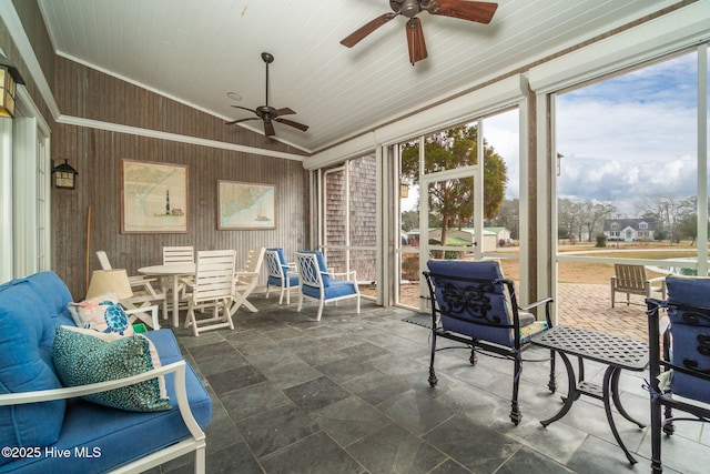 sunroom featuring ceiling fan, wood ceiling, and lofted ceiling