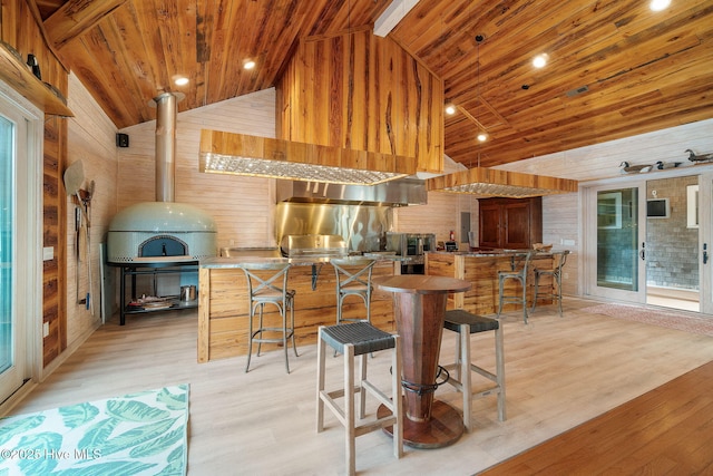 kitchen featuring high vaulted ceiling, wood walls, wood ceiling, and light wood-type flooring