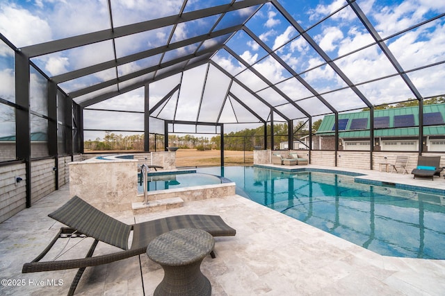 pool with an in ground hot tub, a patio area, and a lanai