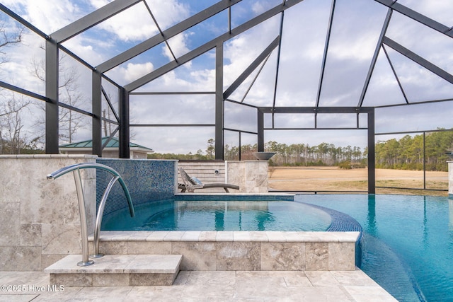 view of pool with glass enclosure