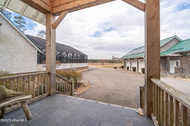 view of patio / terrace featuring a lanai