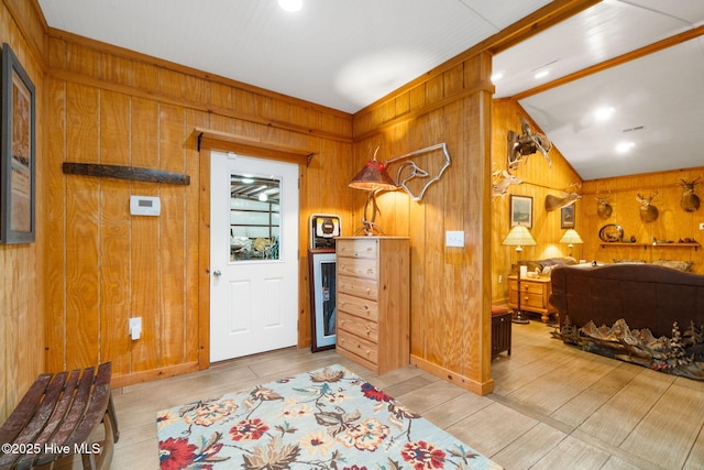 bedroom featuring lofted ceiling, wood finished floors, and wood walls