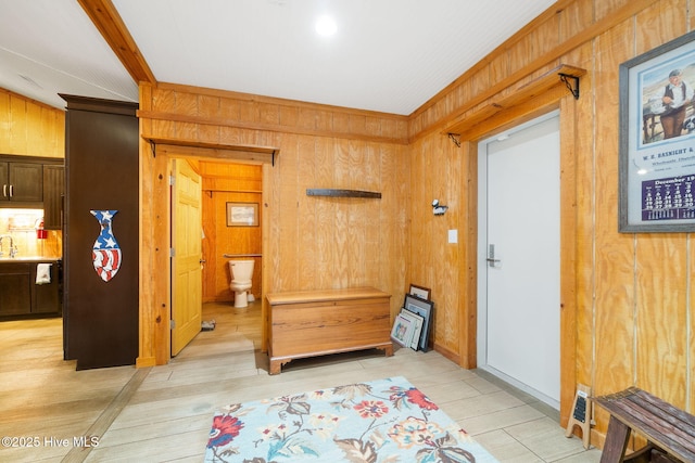 foyer featuring wooden walls and light wood-style flooring