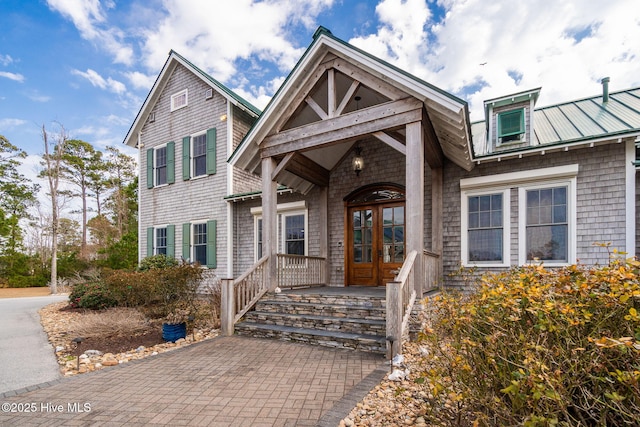 view of front of property featuring french doors and metal roof