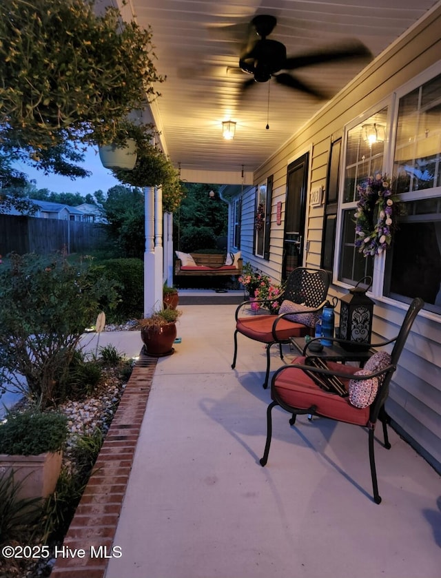 patio terrace at dusk with a porch and ceiling fan