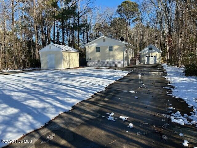 exterior space with a storage shed and a garage