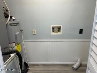 clothes washing area featuring washer hookup and light hardwood / wood-style floors