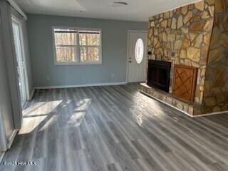 foyer entrance with dark hardwood / wood-style flooring and a fireplace