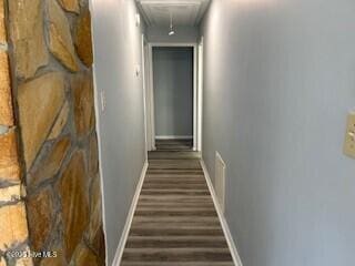 corridor with dark hardwood / wood-style flooring