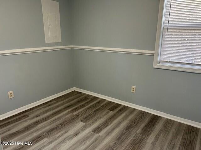 spare room with dark hardwood / wood-style flooring