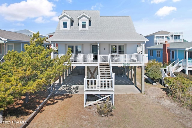 view of front of home featuring a carport and covered porch