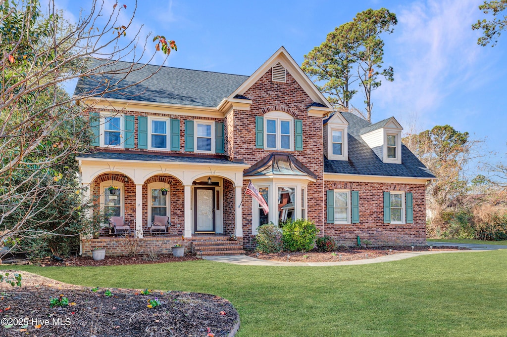 view of front of house featuring a porch and a front lawn