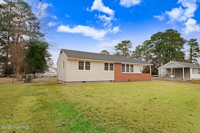 back of property featuring a lawn