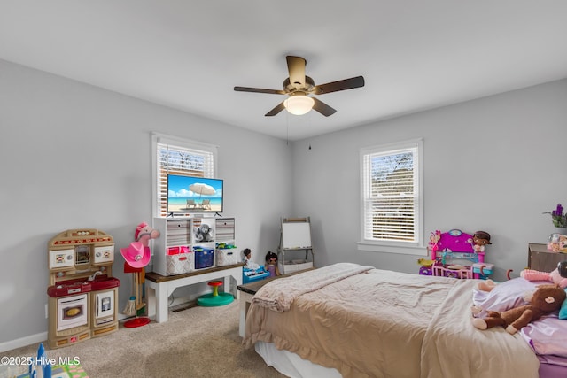 carpeted bedroom featuring ceiling fan and multiple windows