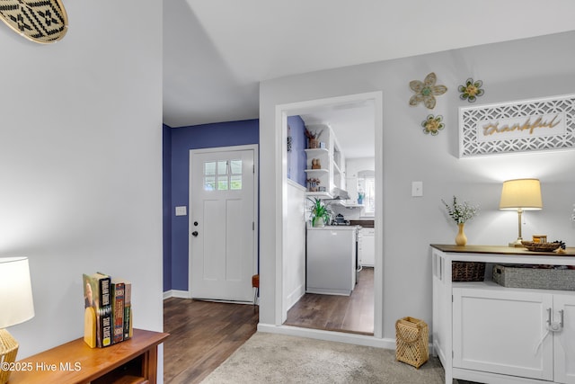 entryway with a healthy amount of sunlight and dark hardwood / wood-style floors