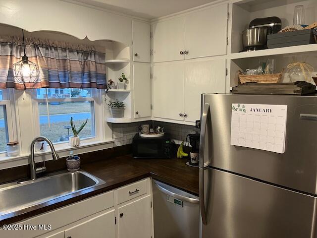 kitchen featuring sink, stainless steel appliances, and white cabinets