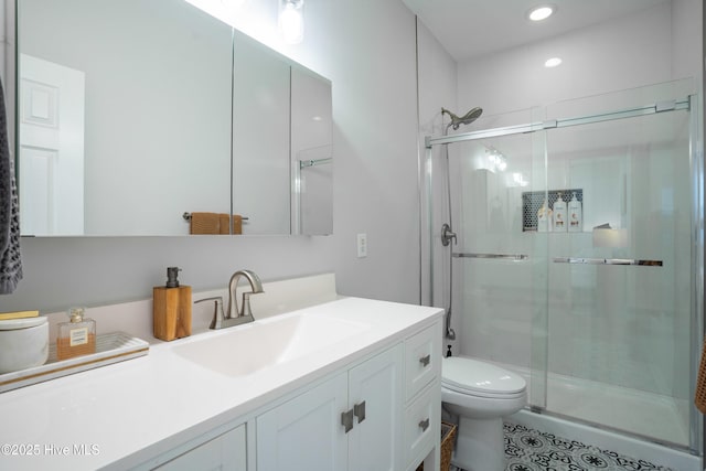 bathroom with vanity, an enclosed shower, and toilet