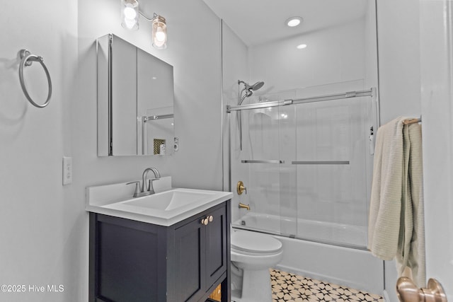 full bathroom featuring vanity, toilet, and combined bath / shower with glass door