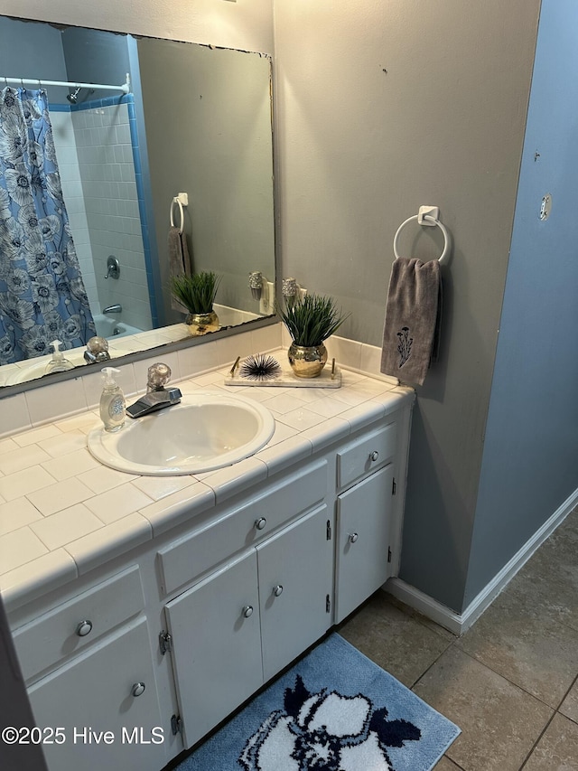 bathroom featuring tile patterned floors, baseboards, and vanity