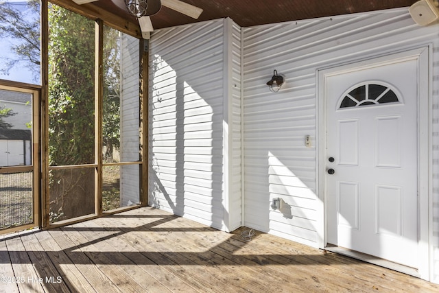 view of exterior entry featuring a wooden deck
