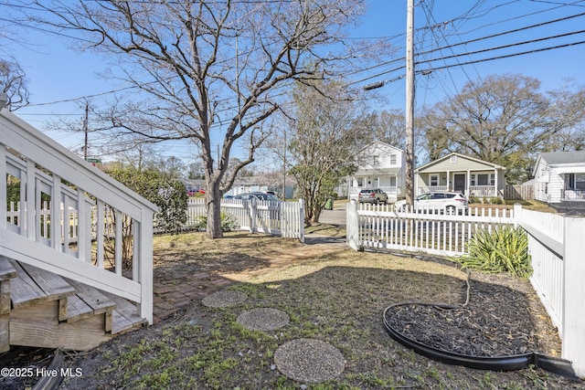 view of yard with a residential view and a fenced front yard