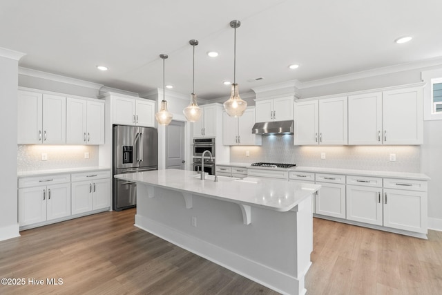 3836 Mason Port Dr, Wilmington, NC 28409 - kitchen featuring stainless steel appliances, under cabinet range hood, light countertops, ornamental molding, and white cabinets
