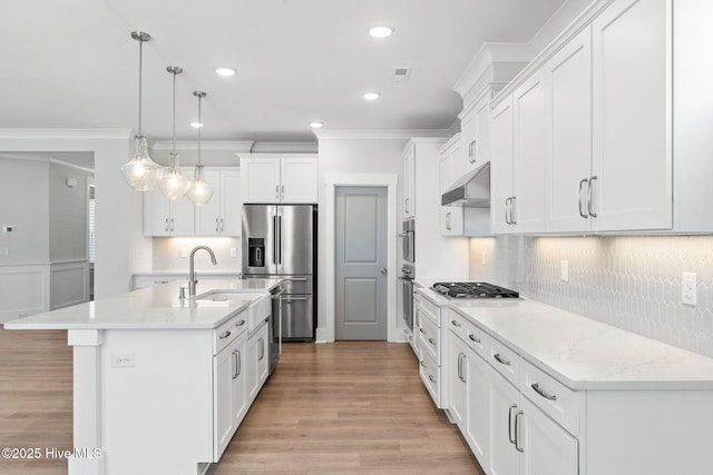 3836 Mason Port Dr, Wilmington, NC 28409 - kitchen with appliances with stainless steel finishes, under cabinet range hood, light wood-style flooring, ornamental molding, and light countertops
