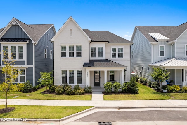 3836 Mason Port Dr, Wilmington, NC 28409 - view of front of property with covered porch, a front yard, board and batten siding, and a shingled roof