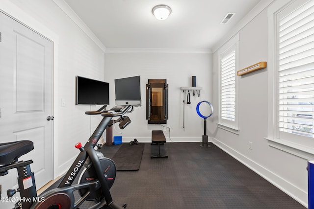 workout room featuring ornamental molding