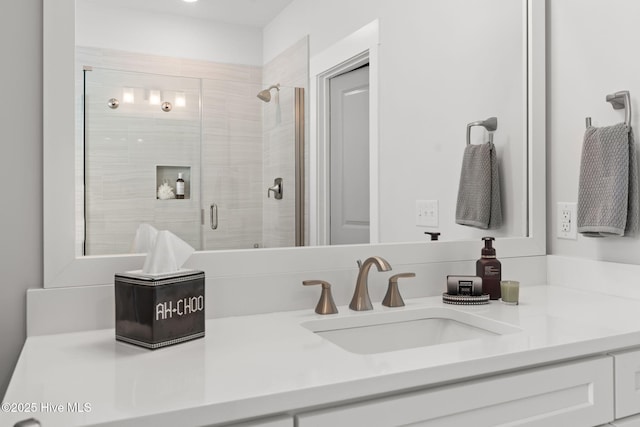 bathroom with vanity and a shower with shower door