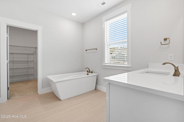 3836 Mason Port Dr, Wilmington, NC 28409 - full bath featuring vanity, a freestanding bath, a walk in closet, and recessed lighting